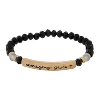 Black Beaded stretch bracelet with a bar focal, stamped with "amazing grace."